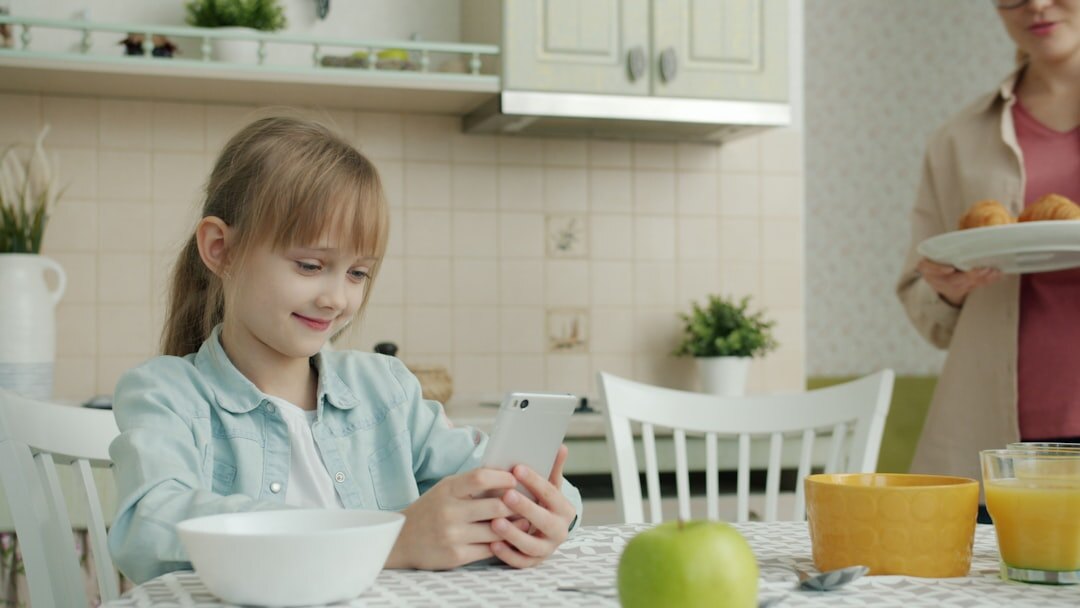 Woman comparing grocery receipts and prices at a kitchen table