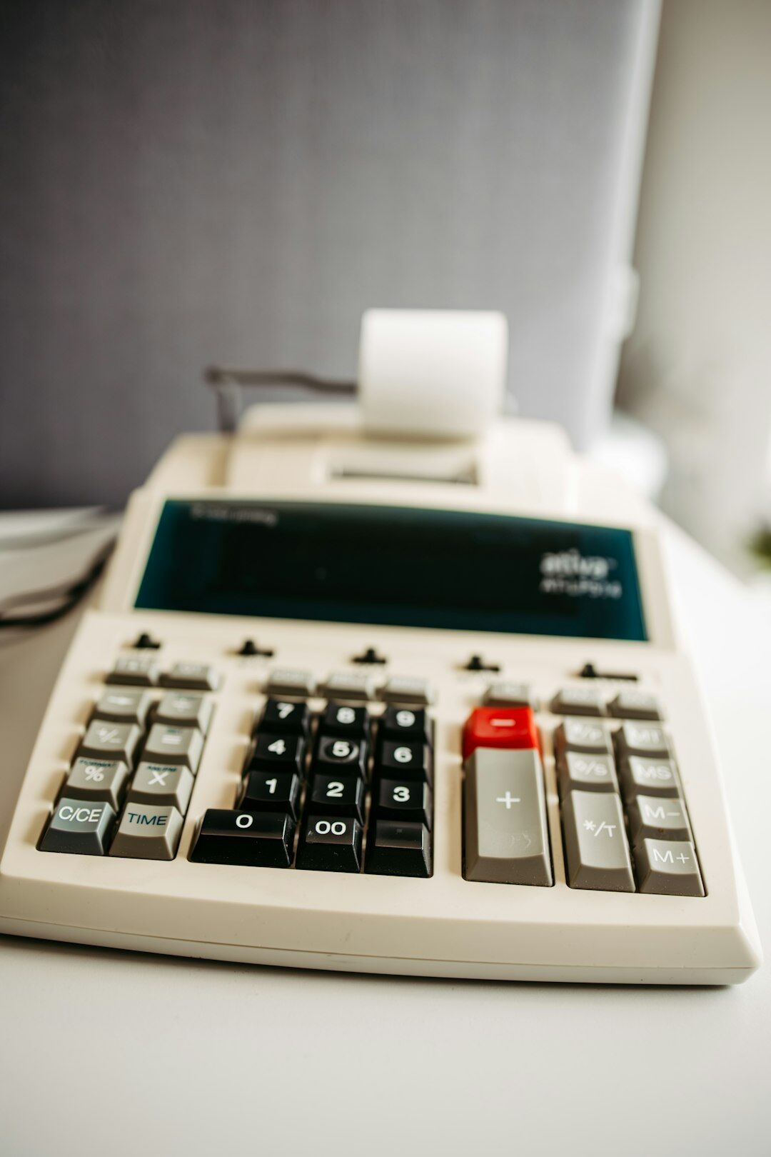 Mature man reviewing household budget notes and a calculator on a desk