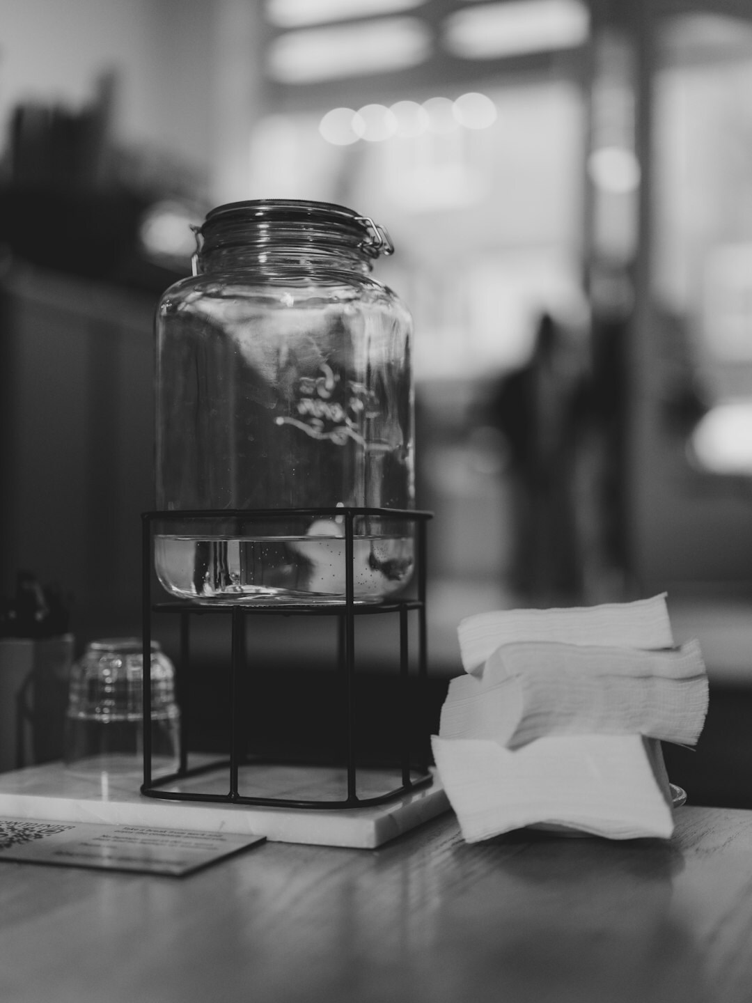 Glass jar filled with coins on a table representing savings habits