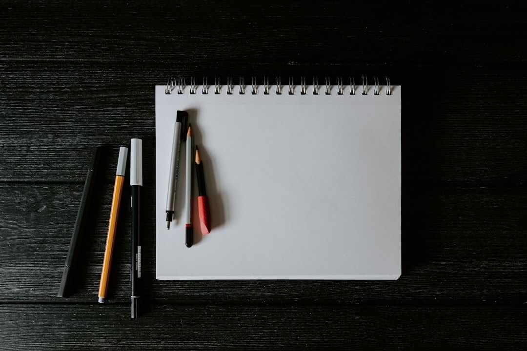 Notebook with a handwritten checklist and a pen on a wooden table